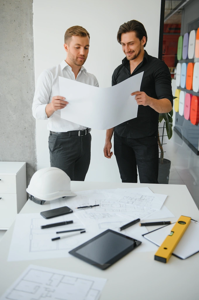 Door specialists reviewing architectural plans during a custom door consultation.